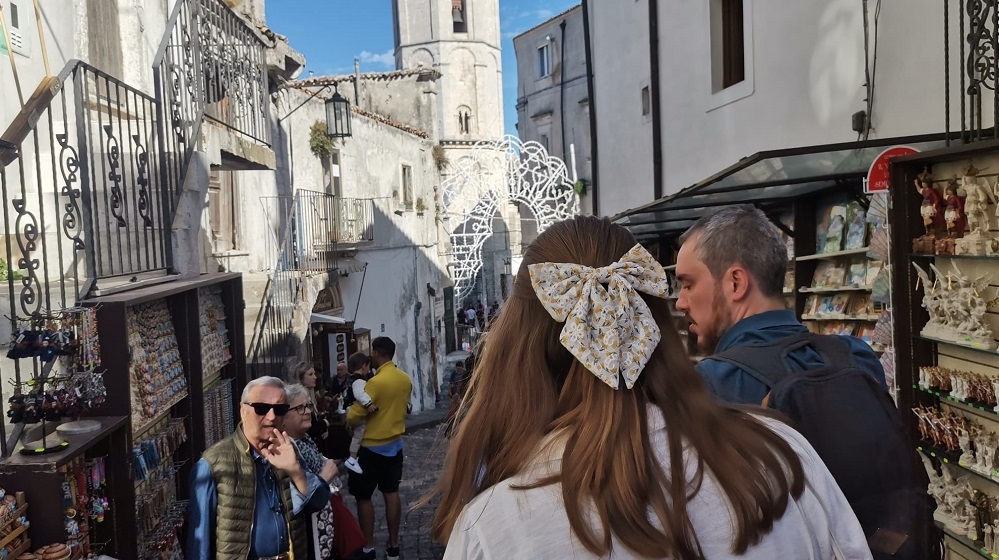 Madelaine Brix strolls through a small town in Puglia with Resident Director Jack Spittle